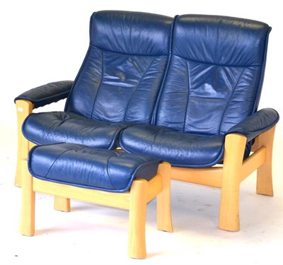 Lot 3215 - An Ekornes Stressless Blue Leather Two-Seater Reclining Settee, with beech frame, 136cm by 65cm...