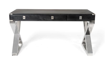 Lot 3238 - A Black Ash and Polished Metal Desk or Hall Table, with three drawers with recessed handles, raised