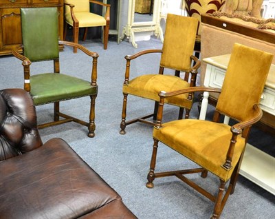 Lot 3263 - A Pair of Oak Framed Armchairs upholstered in close nailed brown suede raised on turned legs,...