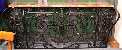 Lot 1001 - A Cast Iron and Marble Top Console Table, with a grey and orange veined marble top, the base of...