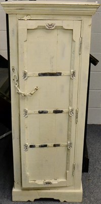 Lot 1002 - A Shabby Chic Cream Painted Cabinet, the cupboard door with metal straps and chain enclosing...