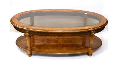 Lot 1020 - A Reproduction Walnut Oval Coffee Table, with bevelled glass plate, reeded tapering supports joined