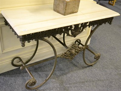 Lot 1032 - A Cast Iron Console/Hall Table, with a rectangular marble top above a C scroll base with...
