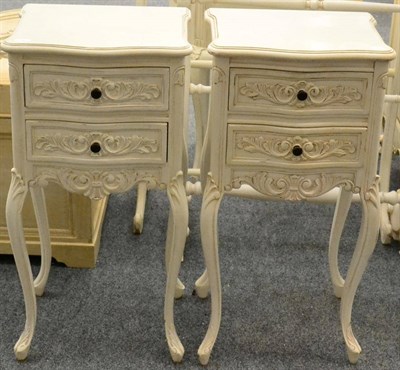 Lot 1036 - A Pair of Cream Painted Two Drawer Bedside Cabinets of recent date, of serpentine shaped form...