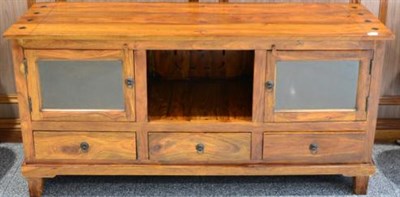 Lot 1052 - A Hardwood Sideboard or Entertainment Unit of recent date, with glazed doors above three frieze...
