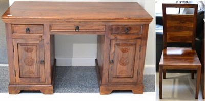 Lot 1053 - A Hardwood Desk of recent date, with three drawers above two cupboard doors, raised on a...