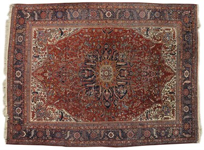 Lot 837 - Heriz Carpet Persian Azerbaijan The terracotta field of angular vines around an indigo pole...