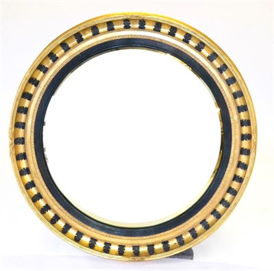 Lot 1075 - A Regency Style Gilt and Gesso Convex Wall Mirror of recent date, with reeded ebonised slip,...