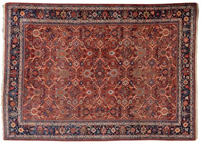 Lot 839 - Mahal Carpet West Persia The madder angular lattice vine field containing large flowerheads...