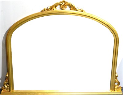 Lot 1089 - A Reproduction Gilt Overmantel Mirror in the Victorian style, an arched bevel glass plate...