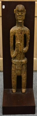 Lot 1097 - A 19th Century Carved Wood Ancestor Figure, standing wearing a loin cloth, his hands raised to...