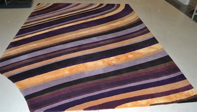 Lot 1098 - A Custom Eight-Colour Design Wool Carpet, of recent date, with brown, black, purple, lilac,...