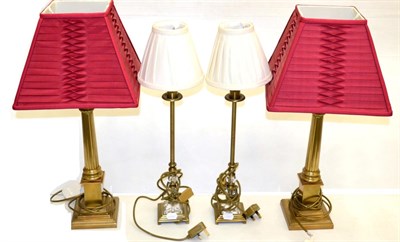 Lot 1111 - A Pair of Brass Corinthian Column Table Lamps, with fluted supports and stepped bases, red gathered