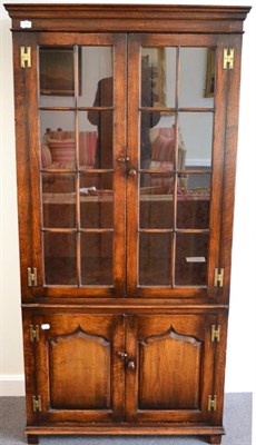 Lot 1116 - A Titchmarsh &amp; Goodwin Oak Bookcase, model RL20546/FP, the glazed doors with H brass hinges...