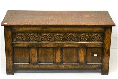 Lot 1124 - A Reproduction Joined Oak Chest, in 18th century style, the hinged lid above a lunette carved panel