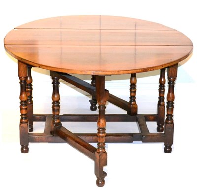 Lot 1127 - A Titchmarsh &amp; Goodwin Oak Six-Seater Double Gateleg Table, two leaves to form an oval,...