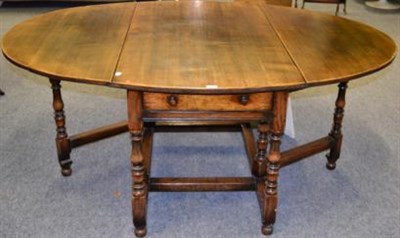 Lot 1129 - A Titchmarsh & Goodwin Reproduction Oak Dropleaf Dining Table, with two leaves to form an oval...