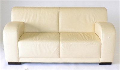 Lot 1159 - A Pair of Cream Leather Sofas, of recent date, comprising a three-seater sofa with rounded arms and