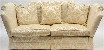 Lot 1164 - A Modern Three-Seater Knole Style Sofa, upholstered in cream fleur de lys style fabric, with...