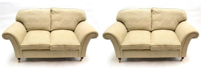 Lot 1165 - A Pair of Laura Ashley Sofas, upholstered in beige fabric, comprising three-seater sofa with...