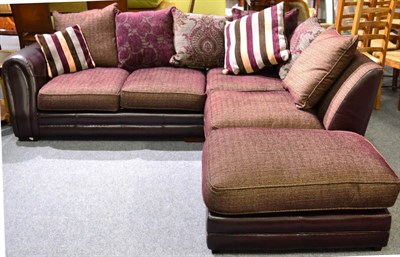 Lot 1168 - A Leather and Red Fabric Four-Seater Corner Sofa, with scatter cushions, maximum width 260cm; and A