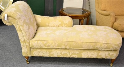 Lot 1169 - A Reproduction Chaise Longue of recent date, upholstered in cream floral fabric over stuffed...