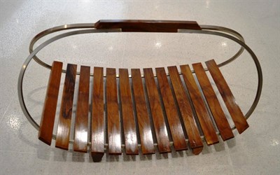 Lot 1005 - A Walnut and Metal Framed Magazine Rack, circa 1990, of curved form with carrying handle, the...