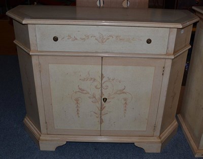 Lot 1007 - An Italian Style Cream Painted Sideboard, of recent date, of canted form with a single frieze...