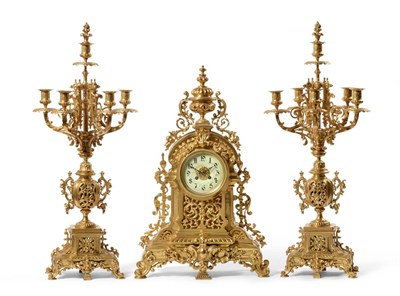 Lot 900 - An Ormolu Striking Mantel Clock with Garniture, circa 1890, the elaborate case surmounted by an urn