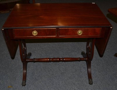 Lot 1037 - A Reproduction Mahogany Drop Leaf Sofa Table, labelled J Sydney Smith, fitted two frieze...
