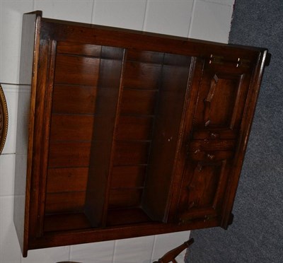 Lot 1051 - A Titchmarsh & Goodwin Oak Dwarf Bookcase, with two shelves above two fielded cupboard doors,...