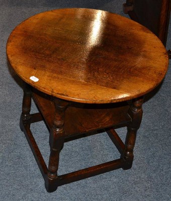 Lot 1052 - A Titchmarsh & Goodwin Oak Circular Occasional Table, with a square shelf below and turned...
