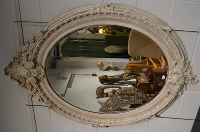 Lot 1104 - A Victorian Style Bevelled Glass Mirror, of recent date, the oval plate within a cream crackle...