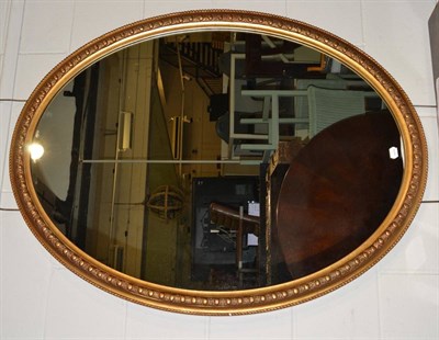 Lot 1106 - A Victorian Style Gilt Painted Oval Mirror, of recent date, 118cm by 91cm