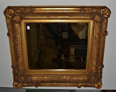 Lot 1122 - A Reproduction Gilt Composition Bevelled Glass Mirror, the rectangular plate surrounded by an...