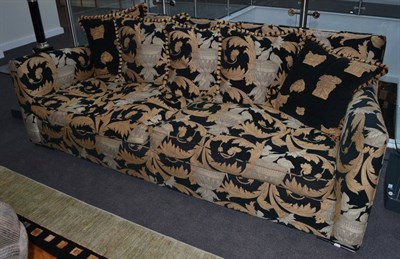 Lot 1124 - A Duresta Three-Seater Sofa, of recent date, printed in black and gold Versace style fabric,...