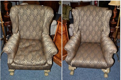 Lot 1135 - A Late 19th/Early 20th Century Wingback Armchair, recovered in dark grey and silver patterned...