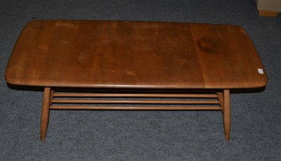 Lot 1148 - An Ercol Light Elm Coffee Table, unmarked, of rectangular rounded form with four legs joined by...