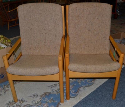 Lot 1153 - A Pair of Ercol Beech Framed Easy Chairs, with calico upholstered squab cushions, 60cm by 50cm...