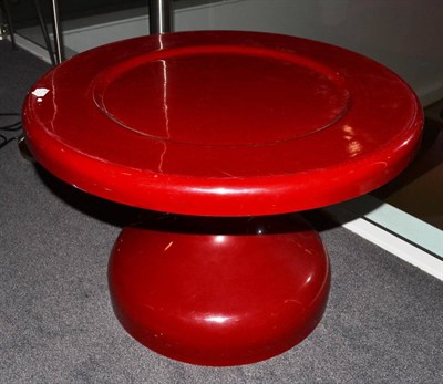 Lot 1155 - A 1970's Red Fibreglass Coffee Table, on a pedestal base, unmarked, 60cm diameter, 39cm high