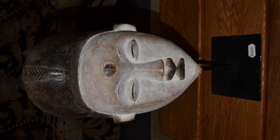 Lot 1198 - A Punu Mask, with white painted face, 50cm high