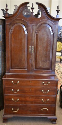 Lot 1002 - A Mahogany Bookcase/Chest, the moulded pediment with three spiral turned urns above cupboard...