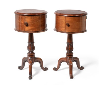 Lot 1011 - A Pair of Victorian Mahogany Circular Pedestal Cupboards, mid 19th century, with later tops...