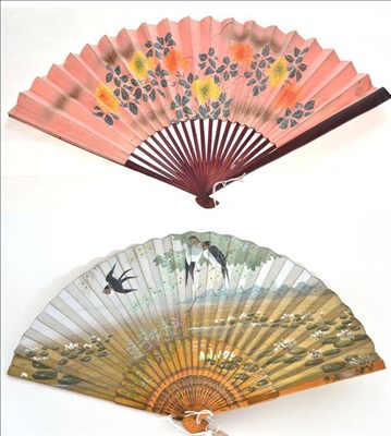 Lot 450 - A 20th Century Japanese Fan, with simple wooden sticks dyed aubergine, mounted with a double...
