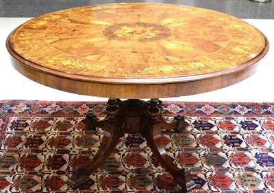 Lot 1034 - A Victorian Figured and Burr Walnut Circular Table, circa 1860, the quarter-veneered top richly...