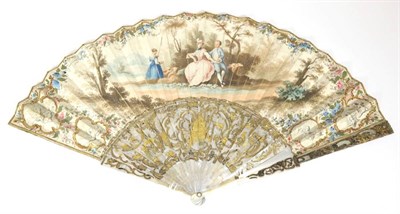 Lot 56 - Pastoral Scene: An 18th Century Mother-of-Pearl Fan, with carved, pierced and gilded sticks....