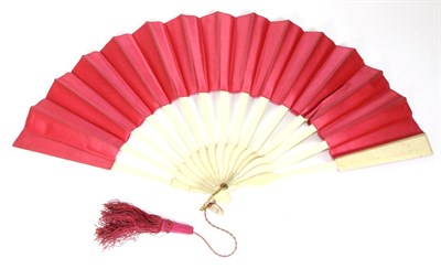 Lot 134 - A European Telescopic Fan, the ivory sticks mounted with a deep pink double silk leaf, undecorated.
