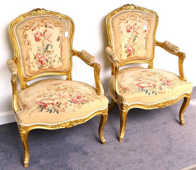 Lot 1112 - A Pair of Louis XV Style Carved Giltwood Fauteuil, late 19th century, with moulded and flower...