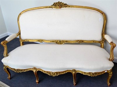 Lot 1124 - A Louis XV Style Gilt and Gesso Canapé, late 19th century, upholstered in plain cotton fabric, the