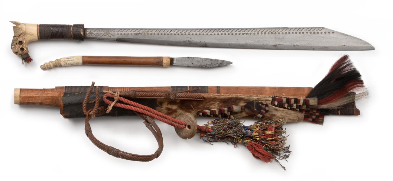 Lot 74 - A Dayak Head Hunter's Sword (Mandau), the 52cm single edge clip point steel blade inlaid to the...